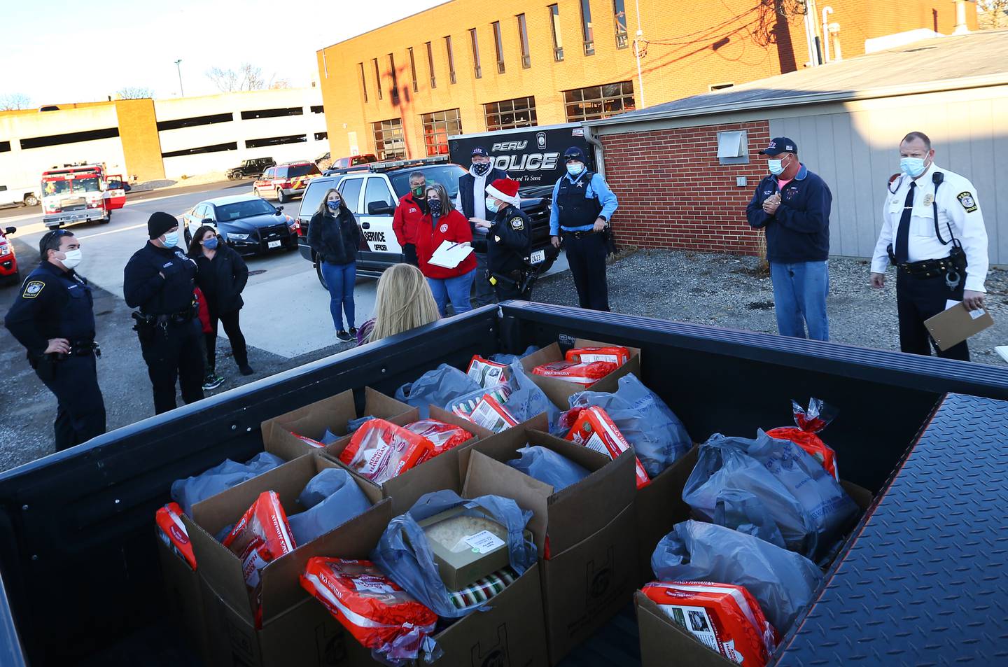 A pickup truck full of food donated by Walmart and Hy-vee was given to families throughout Peru during the Peru Police and Fire Departments "Red and Blue" Christmas Program. Aside from gifts, families also received box of food.