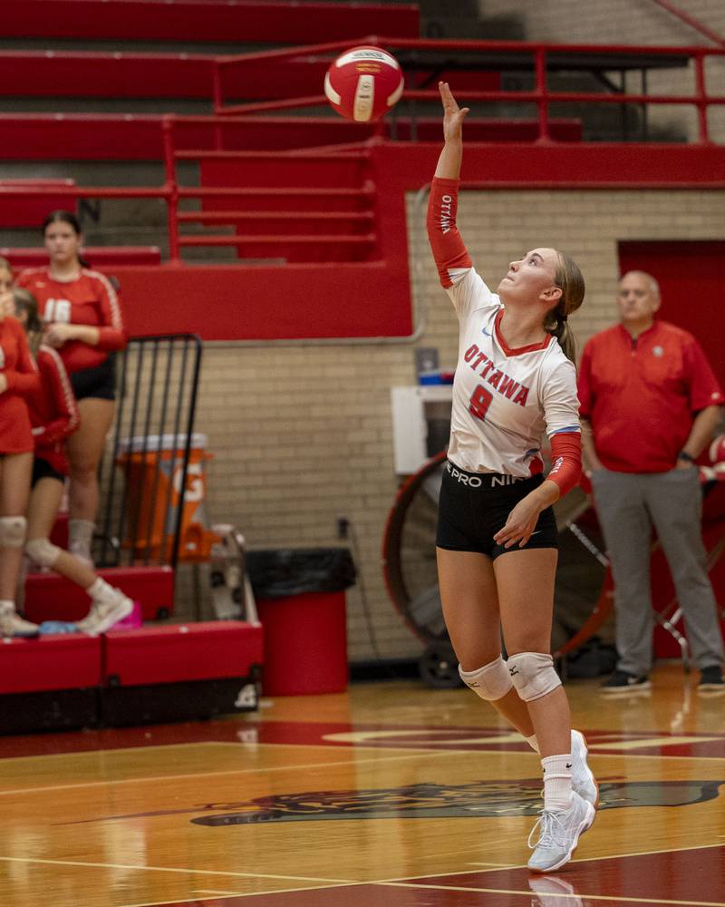 (from left) Ashlynn Ganiere (9) of Ottawa serves volleyball on Thursday, Sept. 18, 2025 at Ottawa High School in Ottawa.