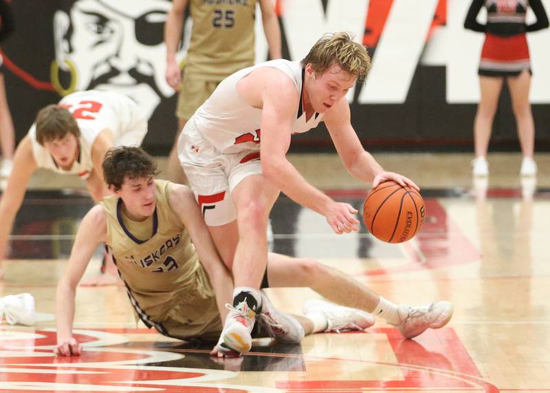 Earlville's Griffin Cook grabs a loost ball over Serena's Hunter Staton on Friday, Feb. 9, 2024 at Earlville High School.