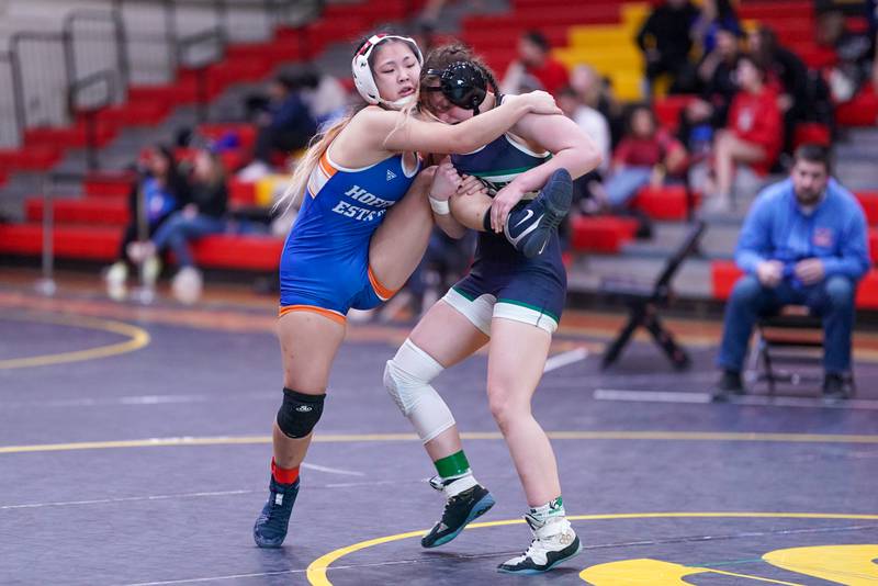 Bartlett’s Lilly White (right) shoots the leg of Hoffman Estates’ Abigail Ji during their 125 pound championship match in the Schaumburg Girls Wrestling Sectional at Schaumburg High School on Saturday, Feb 10, 2024.