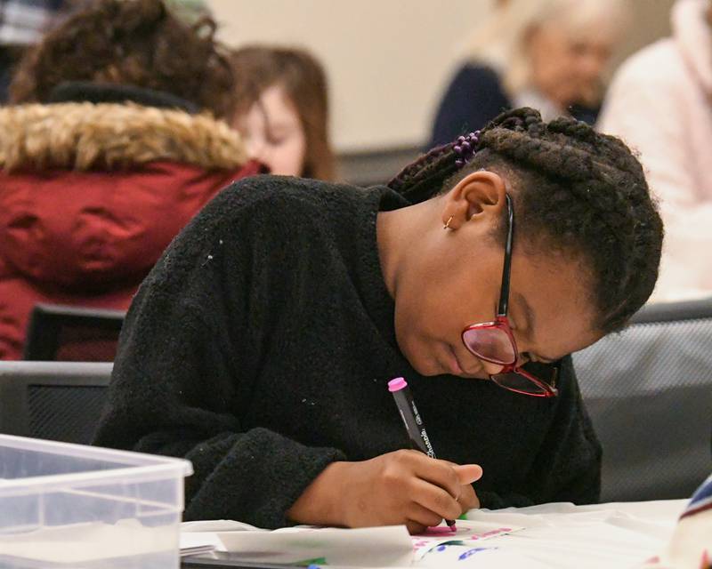 Makayla, 7, of Romeoville help make handmade cards to send to foster homes on Monday Jan. 20, 2025, during the Martin Luther King Jr. Day of Service.