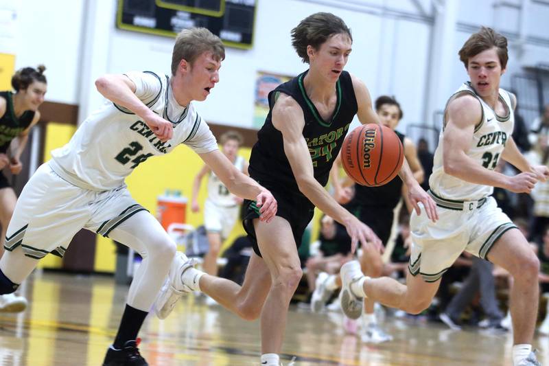 Crystal Lake South’s James Carlson, center, races Grayslake Central’s Dennis Estepp, left, and Jake Kruse, right, for the ball during Hinkle Holiday Classic Basketball Tournament title game action at Jacobs High School Friday.