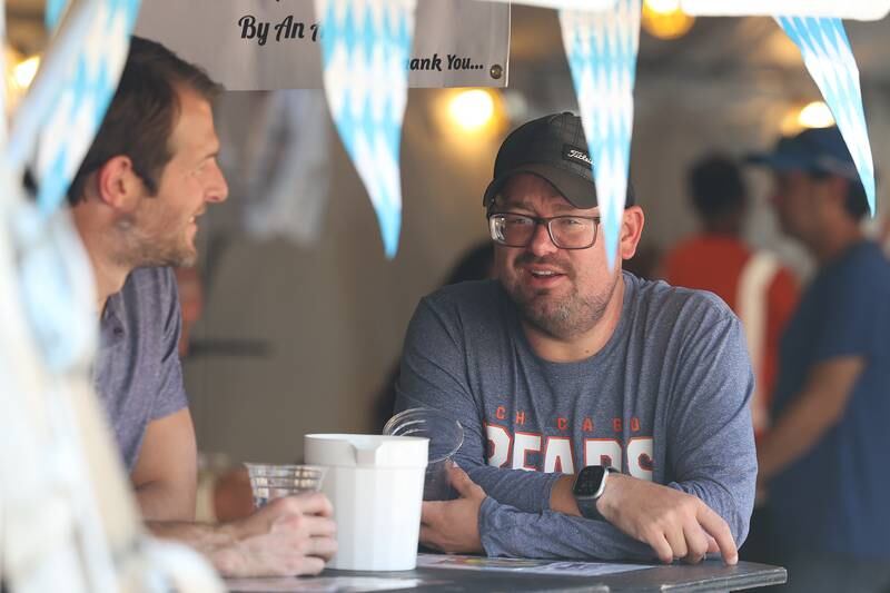 Tyler Weyer, left, and Troy Mikuta enjoy a pitcher of beer in the Beer Tent at the Saint Dennis and Joseph Catholic Academy Annual Oktoberfest on Saturday, Oct. 5, 2024 in Lockport.