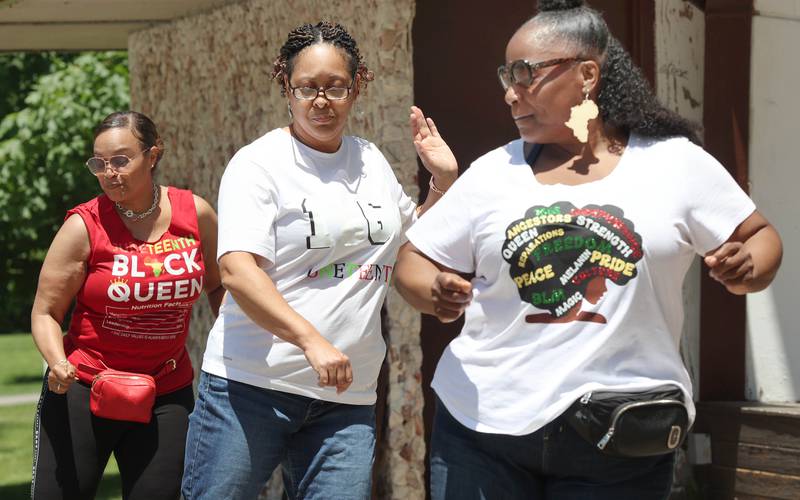 Treveda Redmond, (left) Amber Wilkins and Falin Beck (right) do a little dancing during the second annual Juneteenth celebration Sunday, June 19, 2022, at Hopkins Park in DeKalb.