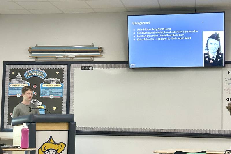 Polo High School Junior Joe Rowland (left) gives his presentation to his class on Thursday, May 15, 2025 about Ellen Ainsworth, an Army nurse who died after refusing to leave her patients in Italy in 1944.