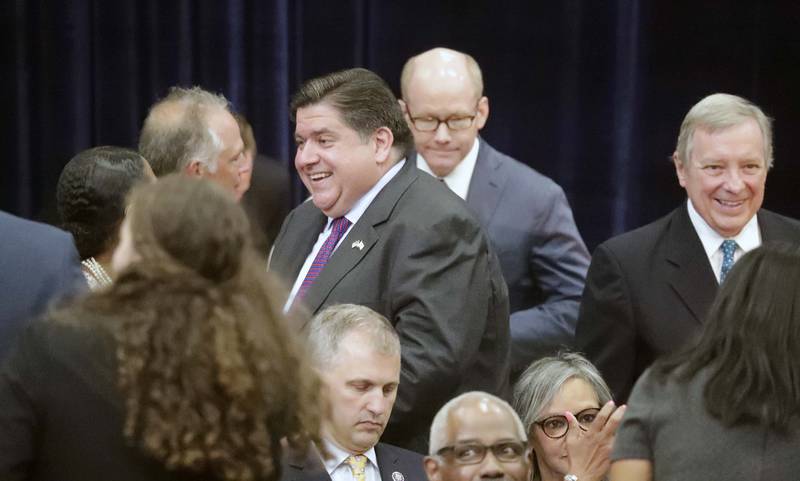 Illinois Governor JB Pritzker greets people before President Joe Biden speaks Wednesday, July 7, 2021, at McHenry County College in Crystal Lake. Also pictured is U.S. Sen. Dick Durbin, far right.