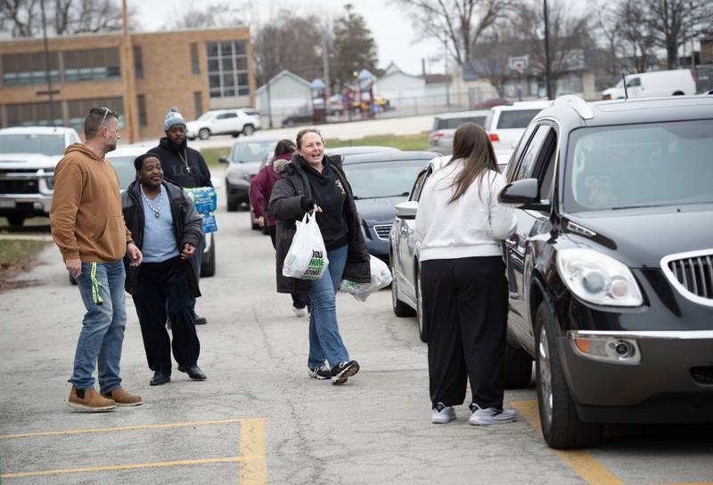 Kankakee School District 111 employees and volunteers hand out bags of donated food during a donation drive by Convoy of Hope at Lincoln Cultural Center in Kankakee on Thursday, March 12, 2026.