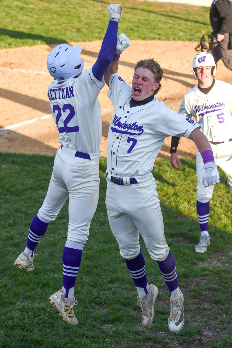 Wilmington's Cooper Holman, right, is congratulated by Ryan Kettman after hitting a grand slam during the Wildcats' 8-1 home win over Herscher Tuesday, April 7, 2026.