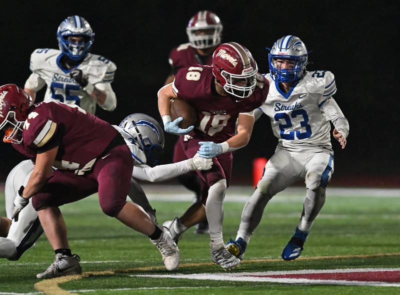 Morris' Logan Conroy (18) looks to pick up a first down during the class 4A first round playoff game against Woodstock on Friday, OCT. 31, 2025, at Morris.