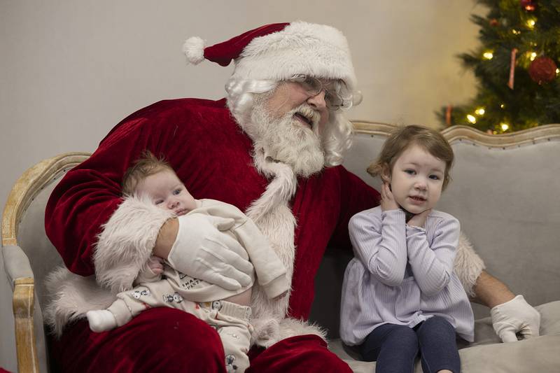 Cayden Jenson, 2 months and Callie Jo Jenson, 2, have pictures taken with Santa Claus Monday, Dec. 16, 2024, at The Facility in Dixon.