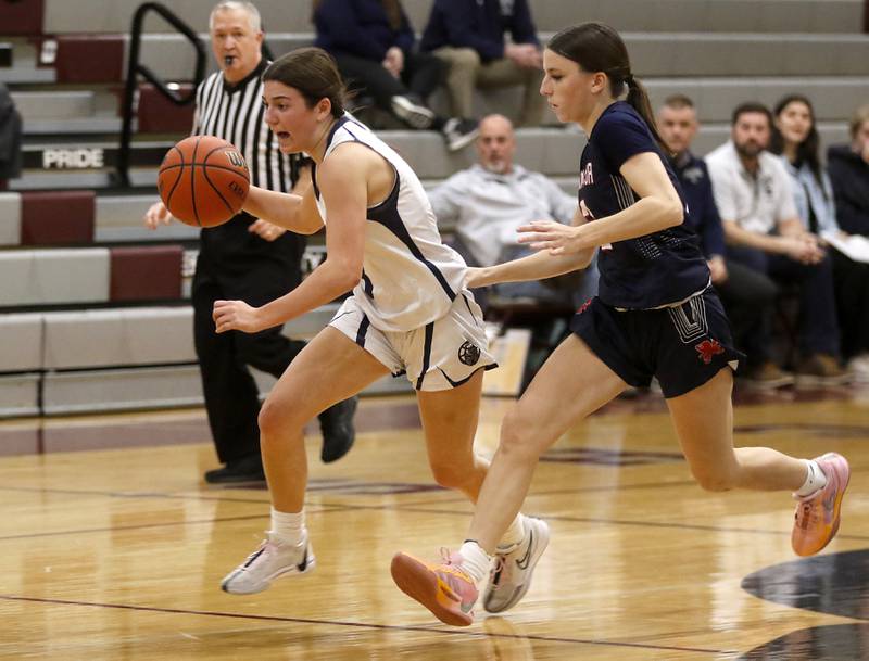 Cary-Grove's Kennedy Manning pushes the ball up the court against St. Viator's Maggie Ratzki during an IHSA Class 3A Antioch Sectional semifinal girls basketball game on Tuesday, Feb. 20, 2024, at Antioch High School.