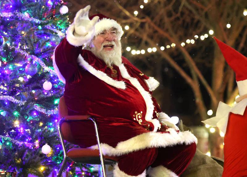 Santa Claus waves to his admirers Thursday, Dec. 5, 2024, in front of the Egyptian Theatre during the DeKalb Chamber of Commerce’s Lights on Lincoln and Santa Comes to Town.