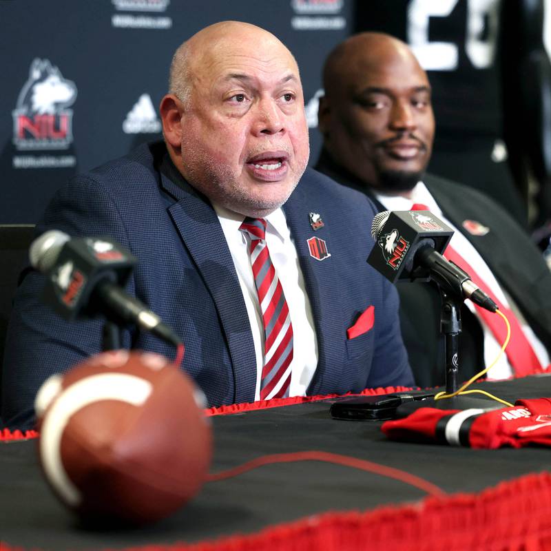 Northern Illinois University vice president and director of athletics and recreation Sean Frazier  (left) answers a question as head football coach Thomas Hammock looks on during a press conference Tuesday, Jan. 7, 2025, announcing that NIU football will be joining the Mountain West Conference starting with the 2026 season.