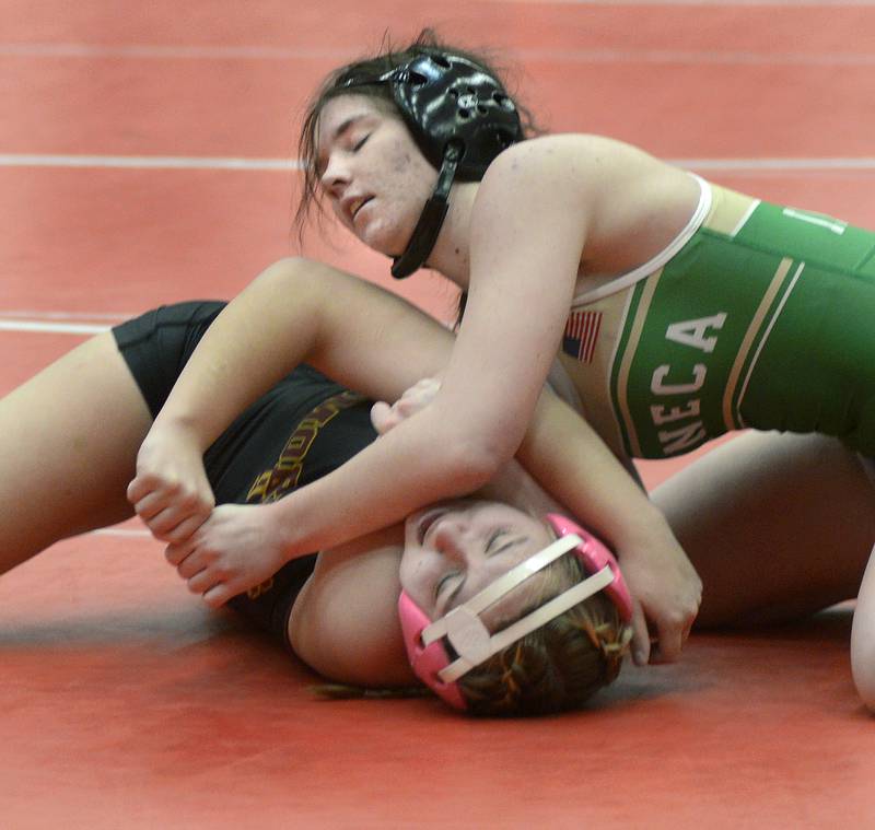 Seneca's Sammie Greisen battles with Morris's Tessa Neikirk in an Elite Bracket 135-pound bout at Monday's Ottawa Holiday Hootenanny Invite in Kingman Gymnasium.