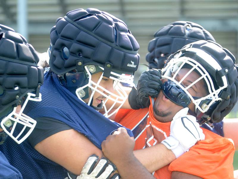 Oswego lineman Gustavo Guzman blocks a teammate during football practice at Oswego High School on Monday, Aug 7, 2023.