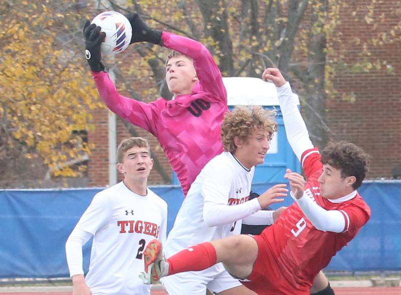 Edwardsville keeper Collin Schlechte makes a save over Hinsdale Central's Christopher Koulouris during the Class 3A State third place game on Saturday, Nov. 9, 2024 at Hoffman Estates High School.