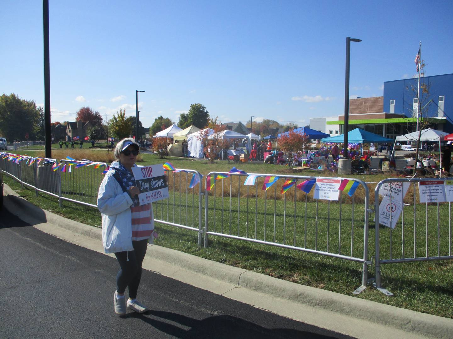 A protester carries a "Stop Drag Show for Kids" at Plainfield Pride Fest on Sunday, Oct. 16, 2022.