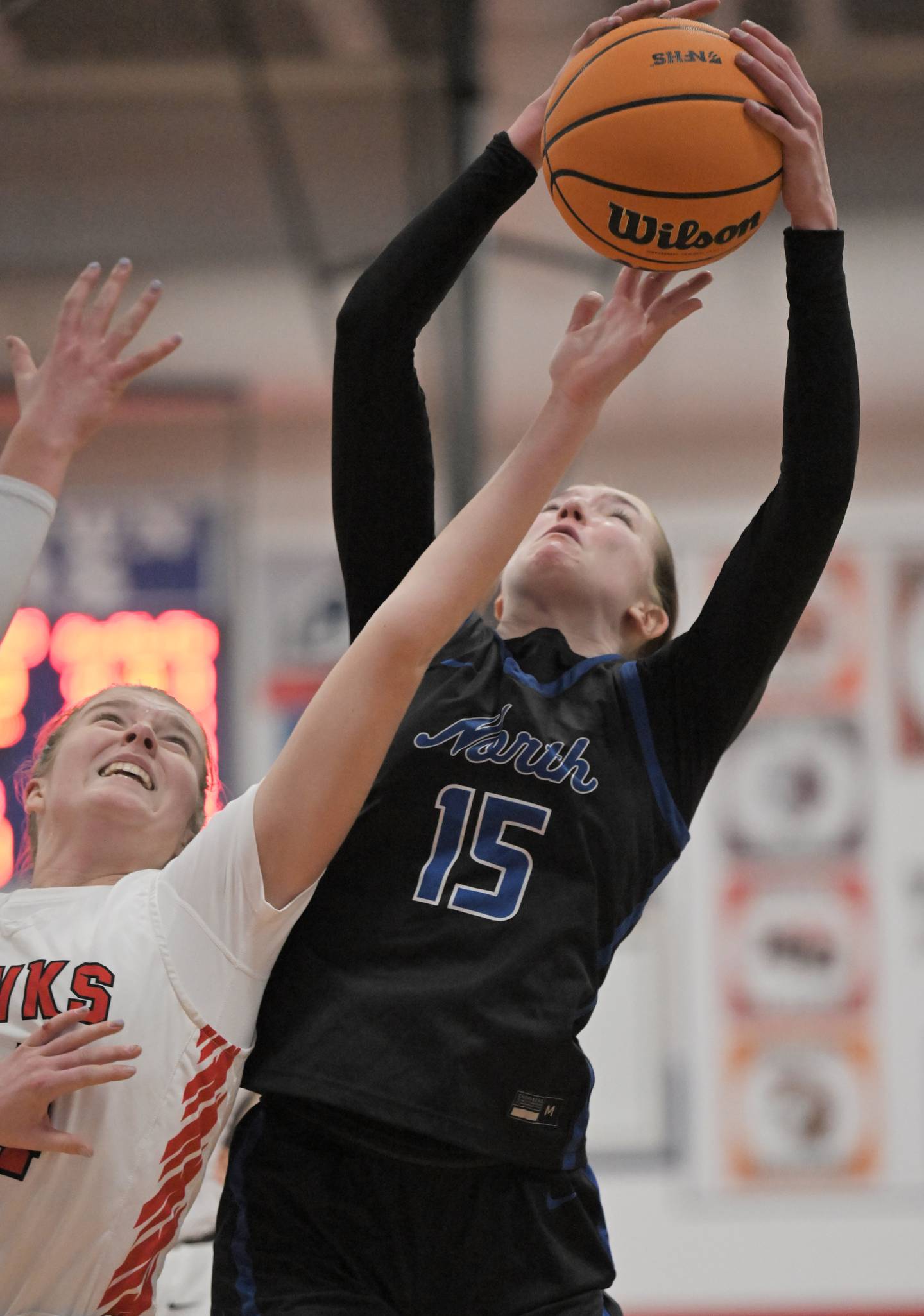St. Charles North’s Bronwyn How gets a rebound against Maine South’s Addie Kopf in a semifinal game of the Dundee-Crown holiday tournament in Carpentersville on Monday, Dec. 29, 2025.