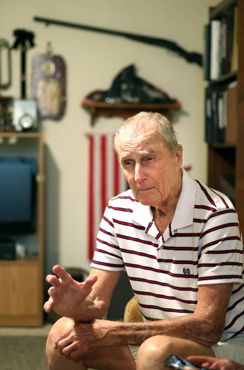 U.S. Army Veteran Jerry Busby talks Wednesday, Aug. 28, 2024, about his time in the service and how it has led to his passion for collecting the military and law enforcement memorabilia that adorn the walls of his DeKalb home.