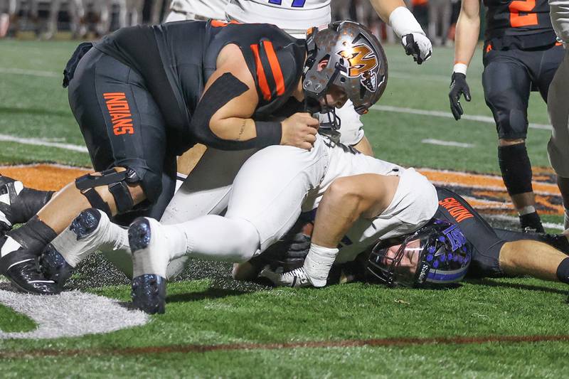 Lincoln-Way East’s Caden O’Rourke falls on the loose ball against Minooka on Friday, Nov. 8, 2024 in Minooka.