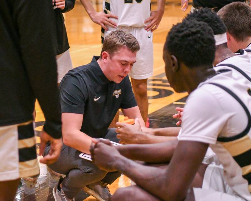 Glenbard North's head coach Kevin Tonn talks to the team between quarters on Tuesday Jan. 6, 2026, as they took on Geneva held at Glenbard North High School.