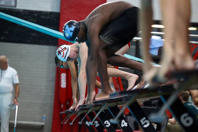 Bradley-Bourbonnais' Eli Swafford prepares to start the 100-yard butterfly race next to Kankakee's Rahman Lawal, near, and Bishop McNamara's Carter Edwards during the All-City meet on Tuesday, Jan. 6, 2026.