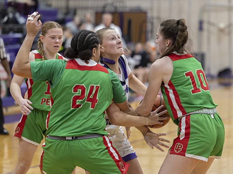 Dixon’s Katie Drew works between a trio LaSalle-Peru players Thursday, Nov. 30, 2023 in Dixon.