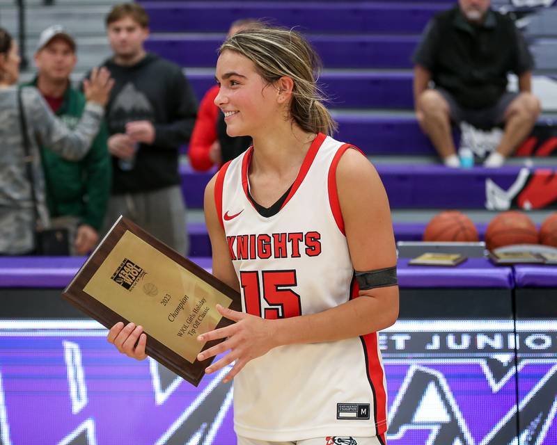 Lincoln Way Central's Gianna Amadio (15) holds the WJOL Tournament Championship game plaque. Nov 18, 2023.