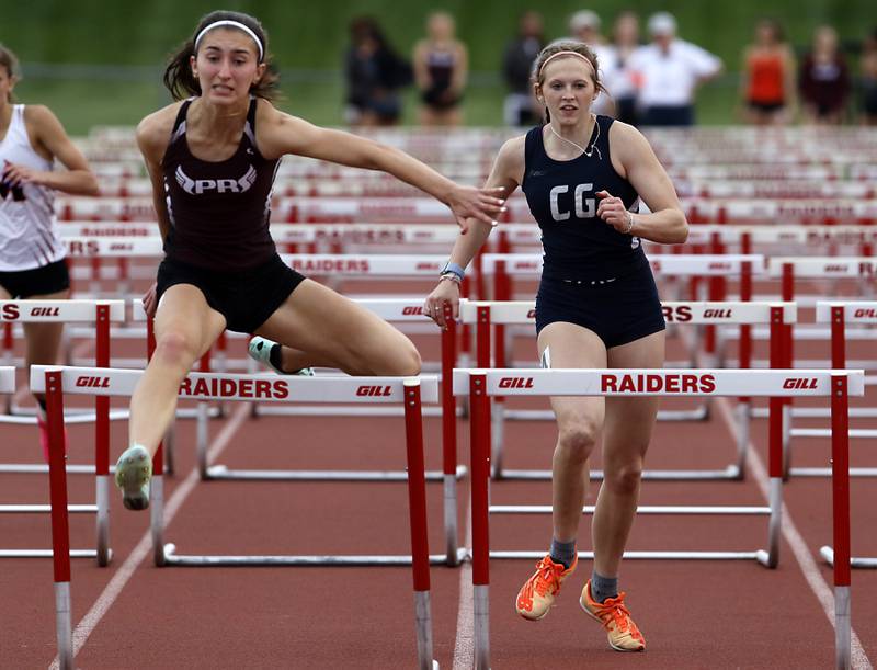 Prairie Ridge’s Rylee Lydon clears the last hurdle  in front Cary-Grove’s Lindsey Kownick Friday, May 5, 2023, during the Fox Valley Conference Girls Track and Field Meet at Huntley High School.