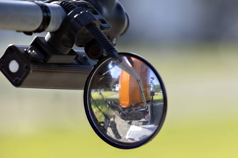 Tim Hickle is reflected in a mirror he has mounted to his rig Friday, Aug. 15, 2025.