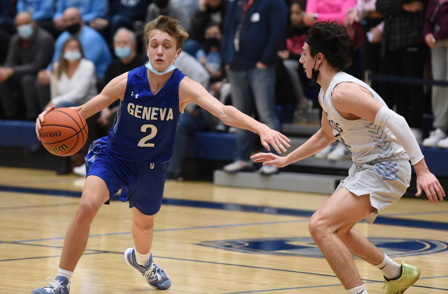 Geneva's Michael Lawrence (2) finds room to work around Lake Park's Vito LaGioia during Wednesday's boys basketball game in Roselle.