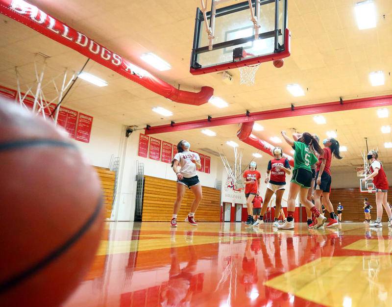 Members of the Streator High School girls basketball team practice in the gym while wearing masks. Student athletes and coaches found out late Tuesday afternoon the IHSA boys and girls basketball seasons, as well as wrestling seasons are on hold.