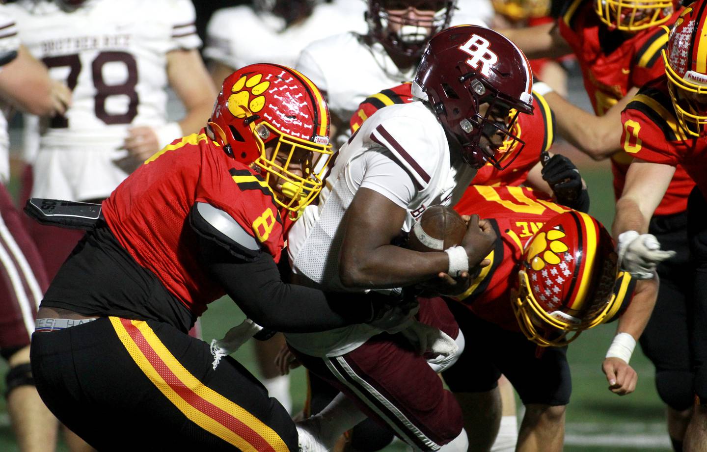 Batavia’s Malachi Smith (left) takes down Brother Rice’s Marcus Brown during a Class 7A round 1 playoff game in Batavia on Friday, Oct. 27, 2023.