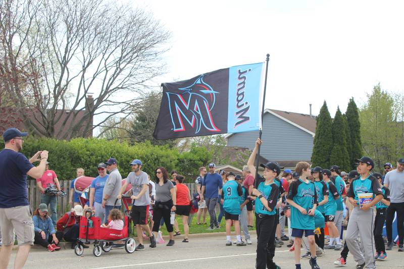 CGYBS players walk down First Street in Cary during the CGYBS season kickoff parade Saturday, April 27, 2024.