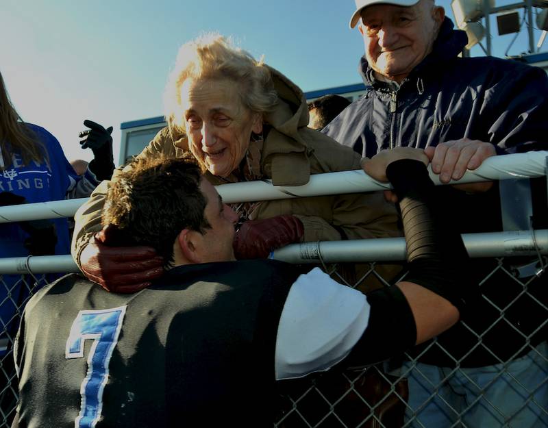 Geneva quarterback Daniel Santacaterina visits with his grandparents, Rena and Reno Santacaterina of Huntley, after Saturday's 7A playoff win against Hersey at Burgess Field.