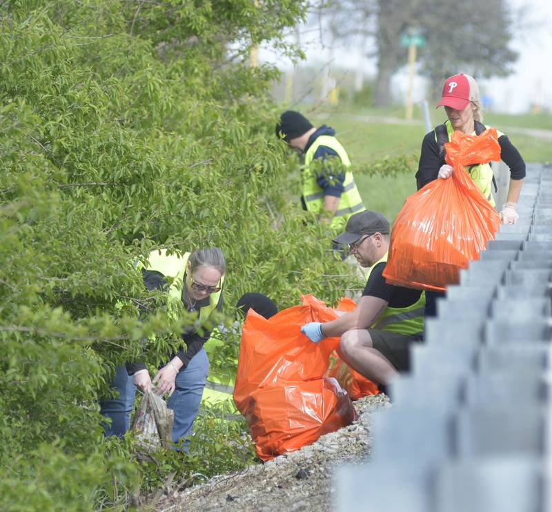 Getting into the thickets an estimated 30 volunteers participated in Operation Clean Sweep by picking up trash along RT 6 west of Ottawa Monday. The volunteers cleanup for 3 hours on the north and south sides of RT 6.