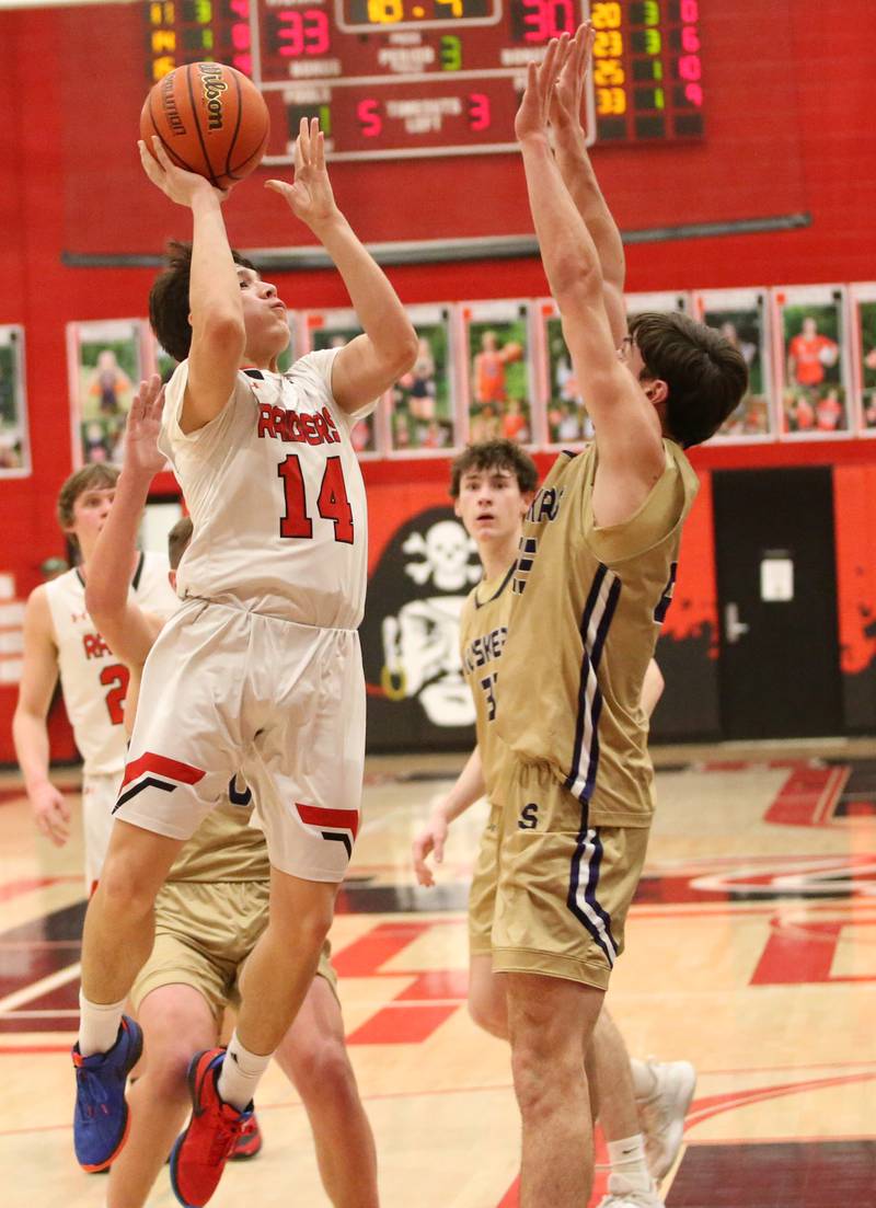Earlville's Oliver Munoz eyes the basket over Serena's Richie Armour on Friday, Feb. 9, 2024 at Earlville High School.