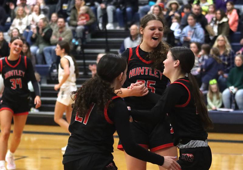 Huntley’s Aubrina Adamik, right, is greeted by teammates Paula Strzelecki, center, and Luca Garlin, left, after drawing a foul in varsity girls basketball on Friday, Jan. 24, 2025, at Cary-Grove High School in Cary.