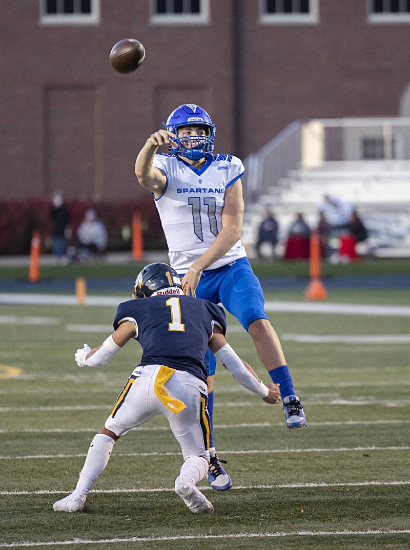 St. Francis’s Alessio Milivojevic fires a pass while being tackled by Sterling’s Joseph Holcomb Saturday, Nov. 4, 2023 in a class 5A playoff game in Sterling.
