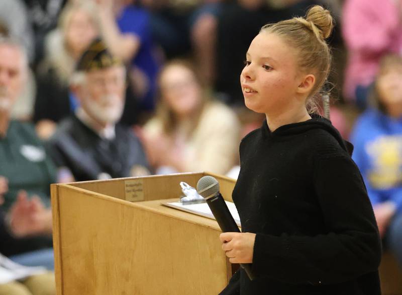 Logan Jr. High student Kaitlin Gill reads his poem during the Veterans Day program on Friday, Nov. 7, 2025 at Logan Jr. High in Princeton .