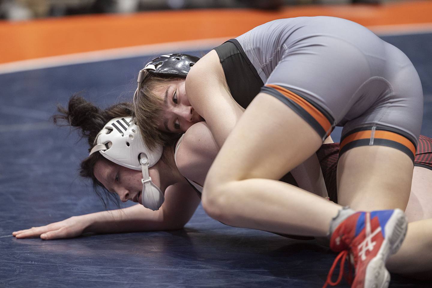 Ashlyn Strenz of Sandwich works on top of Avery Smith of Redbud in the 115-pound third-place match at the IHSA Girls Wrestling State Finals on Saturday, Feb. 25, 2023, in Bloomington.