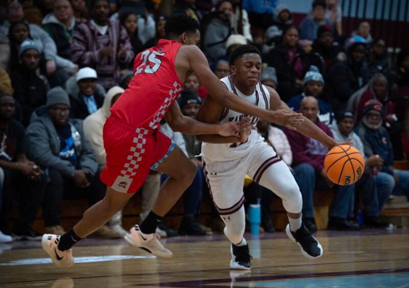 Kankakee's Myair Thompson moves the ball around Rich Township's Jayden Williams during Tuesday's game in Kankakee.