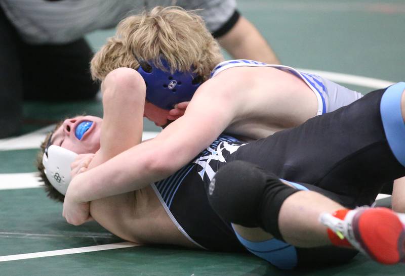 Princeton's Agustus Swanson pins Marquette's Koby Clark in the 120 pound weight class during the Class 1A Regional meet on Saturday, Feb. 8, 2025 at St. Bede Academy.