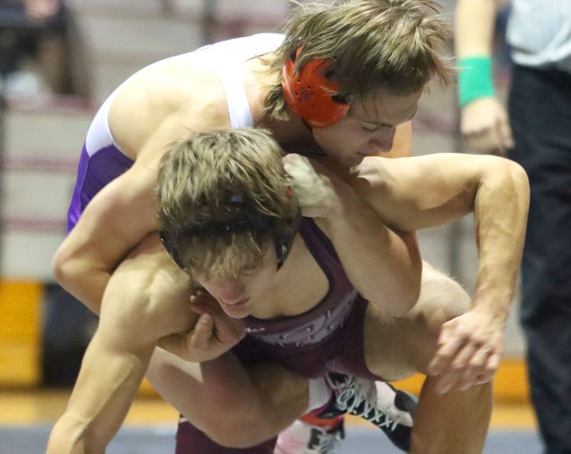 Prairie Ridge’s Andrew Cioper, bottom, battles Hampshire’s Aric Abbott at 150 pounds in varsity boys wrestling on Thursday, Dec. 4, 2025, at  Prairie Ridge High School in Crystal Lake.