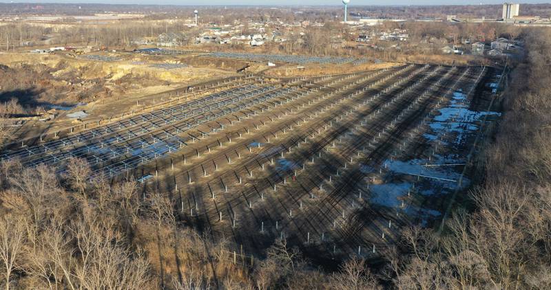 Crews prepare to erect a glass panel on the solar farm located in the 1400 block of North 27th Road (Dee Bennett Road) on Wednesday, Jan. 8, 2026 in Naplate.