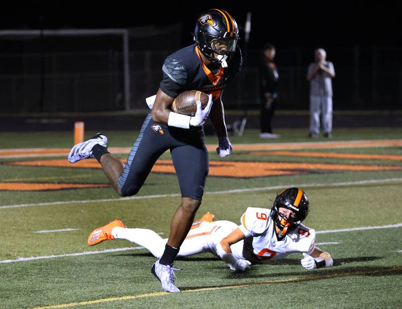 DeKalb's Davon Grant tries breaks the tackle of Lincoln-Way West's Luke Gouty during their game Friday, Oct. 3, 2025, at DeKalb High School.