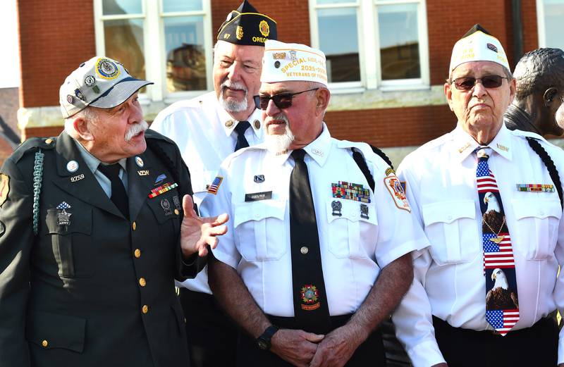 Oregon VFW members John Tuttle, Bob Coulter, and Lee Ossmann chat as they
wait on the Ogle County Courthouse Square to witness the installation of the first Hometown Hero banner on to a city street pole to honor veterans on Thursday, April 23, 2026 in downtown Oregon.