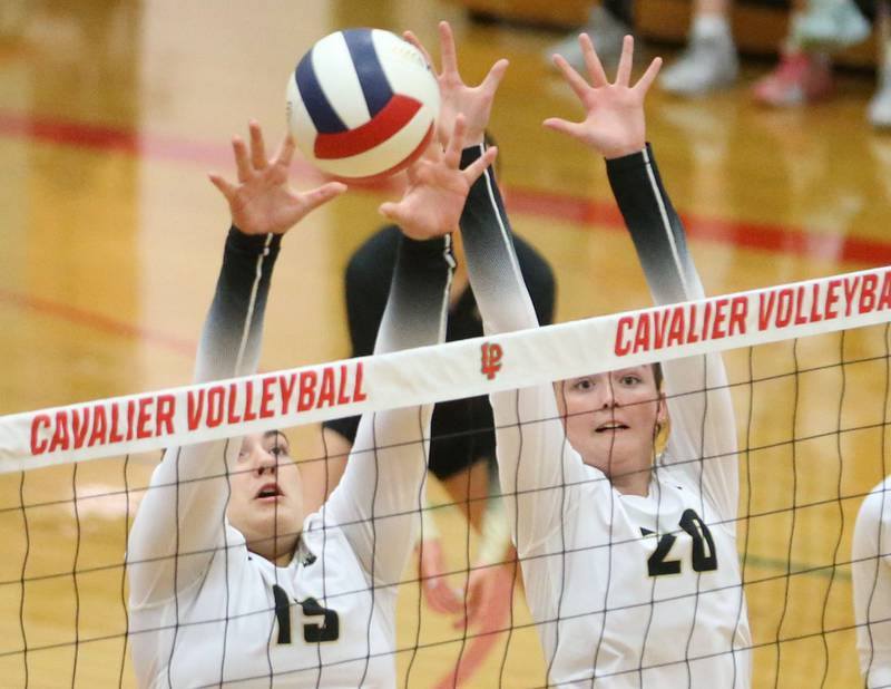 Sycamore's Sophia Martinez and teammate Sophia Martinez block a spike from L-P on Tuesday, Sept. 23, 2025 in Sellett Gymnasium at L-P High School.