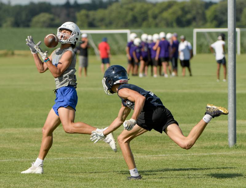 Burlington Central offense catches the ball against Oswego during a 7 on 7 football in Maple Park on Tuesday, July 12, 2022.