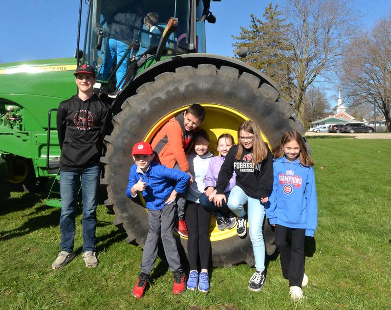 Forreston High School sophomore, Darin Greenfield. (left) poses with Forreston Grade School students from Mrs. Campione's class as they climb on his tractor during the Forreston FFA's Ag Day on Friday, April 12, 2024. Students pictured are: Baylor Krusey, Kendall Tighe. Jordyn Newill, Bryten Meyer, Kennlee Carr-Sieber, and Nicole Penn. The morning event was held on the southwest lawn of the grade school.